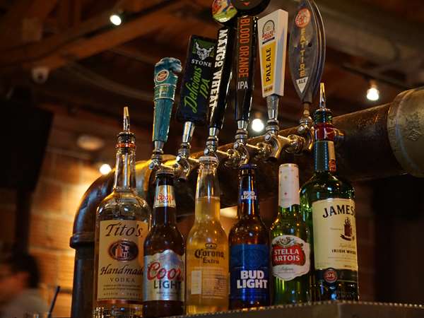 a variety of beer taps at the bar